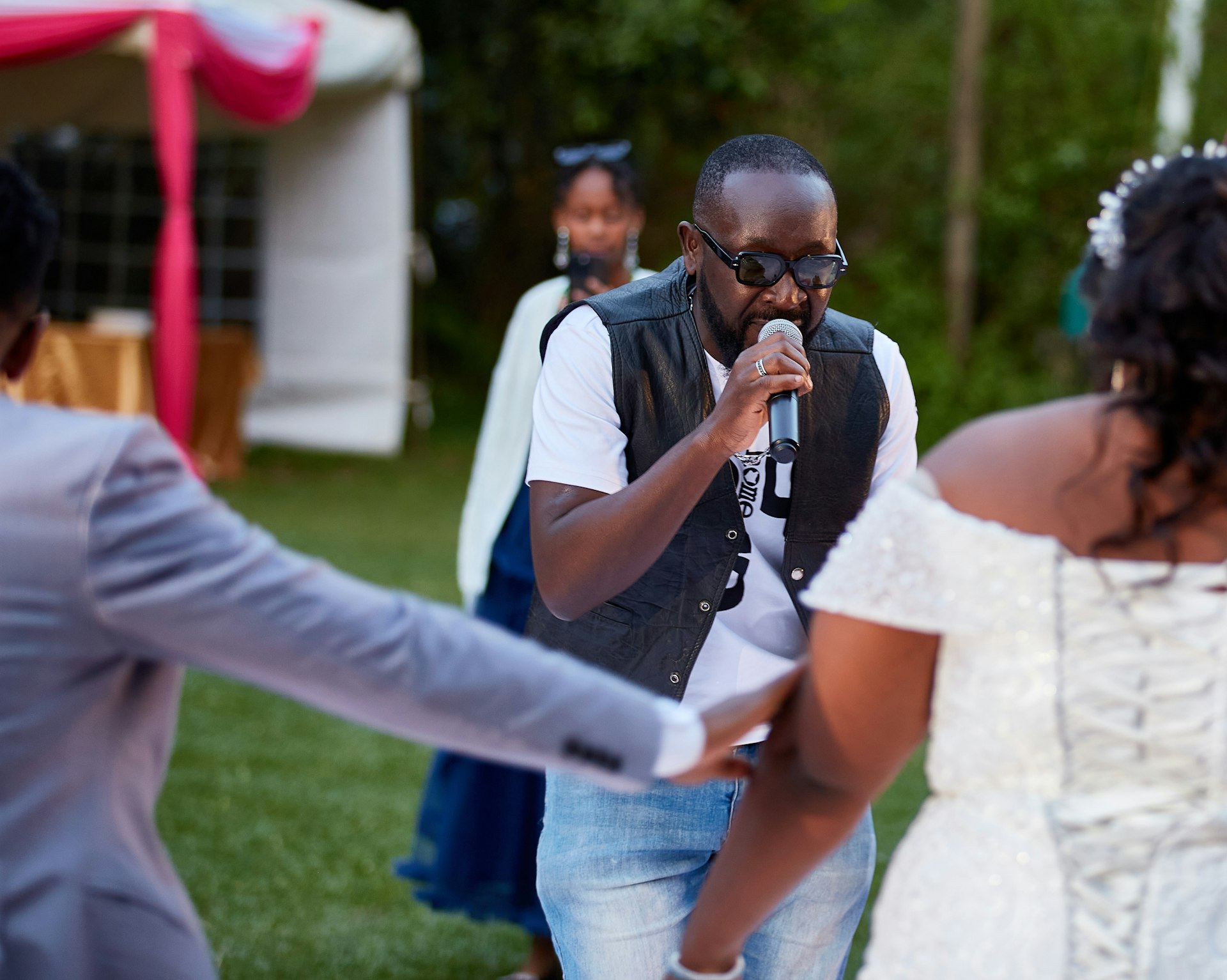 A couple of people that are standing in the grass